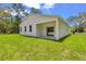 Exterior back view with a covered porch and sliding glass doors at 13101 Sw 85 Pl, Dunnellon, FL 34432