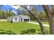 Beautiful home with a manicured lawn, modern design elements, and a long, newly paved driveway at 13101 Sw 85 Pl, Dunnellon, FL 34432