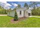 Beautiful home with a manicured lawn, landscaping, and a modern, attached garage at 13101 Sw 85 Pl, Dunnellon, FL 34432