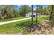 Charming home nestled on a large lot, surrounded by lush greenery and features a long driveway at 13101 Sw 85 Pl, Dunnellon, FL 34432