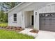 Inviting front entrance showcasing modern design elements and well-maintained landscaping at 13101 Sw 85 Pl, Dunnellon, FL 34432
