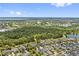 Aerial view showcasing a meticulously landscaped neighborhood with solar panels and mature trees at 13137 Lower Harden Ave, Orlando, FL 32827