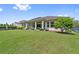 Lush backyard with a covered patio, manicured lawn, and mature trees at 13137 Lower Harden Ave, Orlando, FL 32827