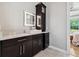 Bathroom with modern dark wood cabinets and drawers, sleek countertop, and lit mirror at 13137 Lower Harden Ave, Orlando, FL 32827
