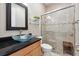 Elegant bathroom with a glass sink, tiled shower, and stone pebble floor at 13137 Lower Harden Ave, Orlando, FL 32827