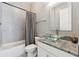 Stylish bathroom featuring a glass bowl sink and tiled bathtub shower at 13137 Lower Harden Ave, Orlando, FL 32827