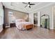 Relaxing bedroom with natural light, tray ceilings, and decorative pendant lighting at 13137 Lower Harden Ave, Orlando, FL 32827