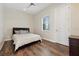 Inviting bedroom with hardwood floors, neutral walls, and a large window at 13137 Lower Harden Ave, Orlando, FL 32827