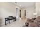 Versatile bonus room features a piano and comfortable seating, perfect for entertainment at 13137 Lower Harden Ave, Orlando, FL 32827