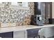 Wet bar in the dining area featuring a stainless steel sink, stylish fixtures, and modern design elements at 13137 Lower Harden Ave, Orlando, FL 32827