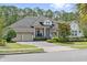 Charming home with a manicured lawn, beautiful landscaping, and a three-car garage at 13137 Lower Harden Ave, Orlando, FL 32827