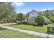 Well-manicured lawn and mature trees enhance the beauty of this charming home at 13137 Lower Harden Ave, Orlando, FL 32827