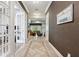 Inviting hallway featuring decorative tile flooring, white trim, and a view of the living area at 13137 Lower Harden Ave, Orlando, FL 32827