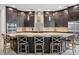 Kitchen with dark cabinets, granite countertops, stainless steel appliances, and a large island with seating at 13137 Lower Harden Ave, Orlando, FL 32827