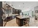 Spacious kitchen boasts dark cabinetry, stainless steel appliances, and large center island at 13137 Lower Harden Ave, Orlando, FL 32827