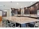 Kitchen featuring dark cabinets, stainless appliances and a granite island with seating at 13137 Lower Harden Ave, Orlando, FL 32827