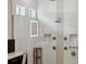 Modern shower design with sleek tiles, multiple shower heads, and built-in storage at 13137 Lower Harden Ave, Orlando, FL 32827