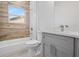 Modern bathroom featuring wood-look tile, sleek gray vanity, and a shower-tub combination at 13163 Sw 70Th Ct, Ocala, FL 34473