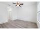 Bright, spacious bedroom with wood-look flooring, a ceiling fan, and ample natural light at 13163 Sw 70Th Ct, Ocala, FL 34473