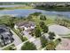 Aerial view of a luxury residence with a manicured lawn situated in a lakeside community at 14285 United Colonies Dr, Winter Garden, FL 34787