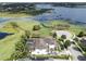 Sprawling home with a pool and a view of the lake, surrounded by mature trees and manicured lawns at 14285 United Colonies Dr, Winter Garden, FL 34787