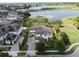 Aerial view of a luxurious home surrounded by lush landscaping and a serene lake at 14285 United Colonies Dr, Winter Garden, FL 34787