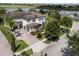 Aerial shot of a well-maintained home featuring a paver driveway, three-car garage, and manicured landscaping at 14285 United Colonies Dr, Winter Garden, FL 34787