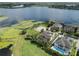 A picturesque view of homes in a lakeside community with lush landscaping, situated on a large, grassy field at 14285 United Colonies Dr, Winter Garden, FL 34787