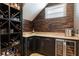 Wine nook featuring custom shelving and stone wall at 14285 United Colonies Dr, Winter Garden, FL 34787