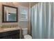 Bathroom featuring granite countertop, stylish mirror, and a shower with a curtain at 14285 United Colonies Dr, Winter Garden, FL 34787
