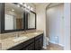 Bathroom with double vanity featuring granite countertops and black framed mirrors at 14285 United Colonies Dr, Winter Garden, FL 34787