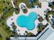 A community pool with beautiful pavers and palm trees from a bird's eye view at 14285 United Colonies Dr, Winter Garden, FL 34787
