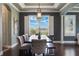 A well-lit dining room featuring a long table, modern chairs, and a view of the tranquil outdoor scenery at 14285 United Colonies Dr, Winter Garden, FL 34787