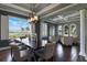 Elegant dining room featuring a dark wood table, decorative lighting, and a scenic window view with lots of natural light at 14285 United Colonies Dr, Winter Garden, FL 34787