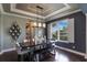 Modern dining room with dark wood flooring, contemporary lighting, and access to the living room and outdoor views at 14285 United Colonies Dr, Winter Garden, FL 34787