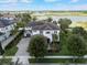 Stunning two-story home boasts lush landscaping, a paver driveway, and lake views at 14285 United Colonies Dr, Winter Garden, FL 34787