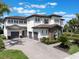 A beautiful home with a 3-car garage and a paver driveway, showcasing its architectural design and curb appeal at 14285 United Colonies Dr, Winter Garden, FL 34787