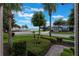 Well-manicured front yard featuring lush landscaping and a view of the lake in the distance at 14285 United Colonies Dr, Winter Garden, FL 34787