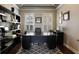 Well-lit home office with modern built-in shelves, a spacious desk, and window shutters at 14285 United Colonies Dr, Winter Garden, FL 34787