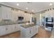 Modern kitchen with an island, stainless appliances, tile backsplash, and ample cabinet space at 14285 United Colonies Dr, Winter Garden, FL 34787