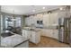 Modern kitchen with white cabinets, granite countertops, stainless steel appliances, and breakfast nook at 14285 United Colonies Dr, Winter Garden, FL 34787