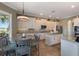 Bright eat-in kitchen featuring white cabinetry, stainless appliances, granite countertops, mosaic backsplash, and tile flooring at 14285 United Colonies Dr, Winter Garden, FL 34787