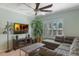 Comfortable living room with a TV, ceiling fan, and a large window for natural light at 14285 United Colonies Dr, Winter Garden, FL 34787