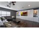 Spacious living room with a large TV, sleek coffee table, and modern ceiling fan at 14285 United Colonies Dr, Winter Garden, FL 34787