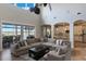 Bright, open living room featuring waterfront views, high ceilings, and access to the pool area at 14285 United Colonies Dr, Winter Garden, FL 34787