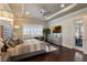 The main bedroom features a tray ceiling, wood floors and access to a patio and ensuite bathroom at 14285 United Colonies Dr, Winter Garden, FL 34787
