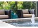 Outdoor patio with decorative chairs, a pool fountain, and vibrant plants at 14285 United Colonies Dr, Winter Garden, FL 34787