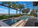 Enclosed pool with fire bowls, a spa, fountain features, and a view of the lake offering a luxurious outdoor experience at 14285 United Colonies Dr, Winter Garden, FL 34787