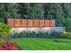 Community sign 'OVERLOOK at Hamlin' set among lush greenery and flowers, creating an inviting and upscale atmosphere at 14285 United Colonies Dr, Winter Garden, FL 34787