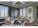 Cozy sitting area with large windows, neutral armchairs, and stylish decor, perfect for relaxing and unwinding at 14285 United Colonies Dr, Winter Garden, FL 34787